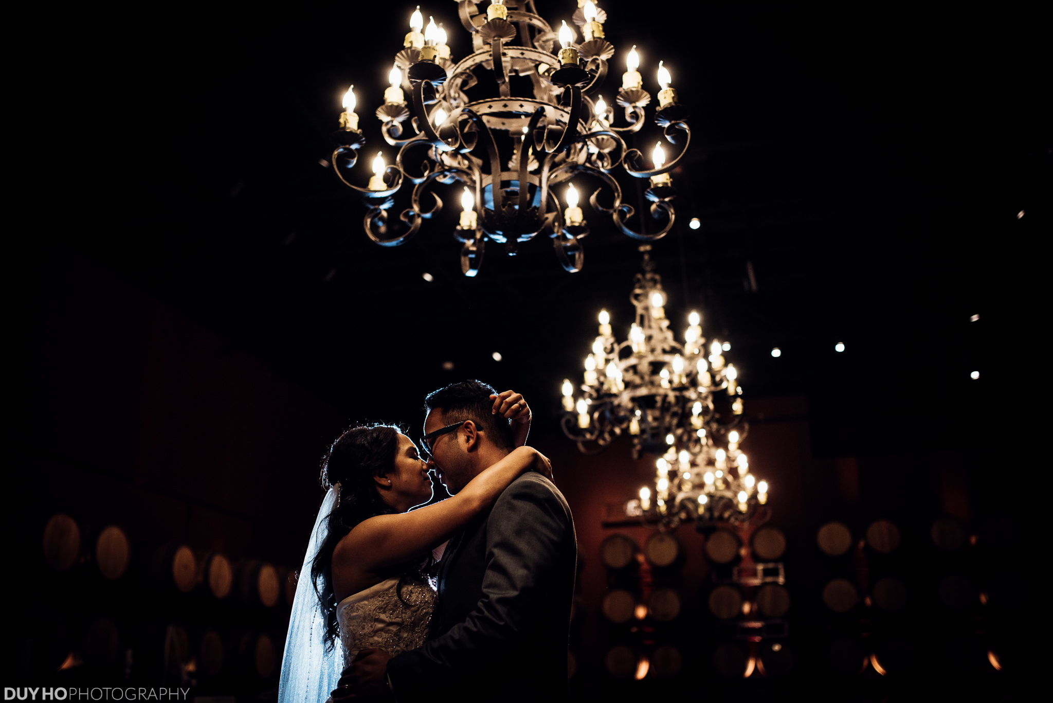 Couple dancing under chandeliers
