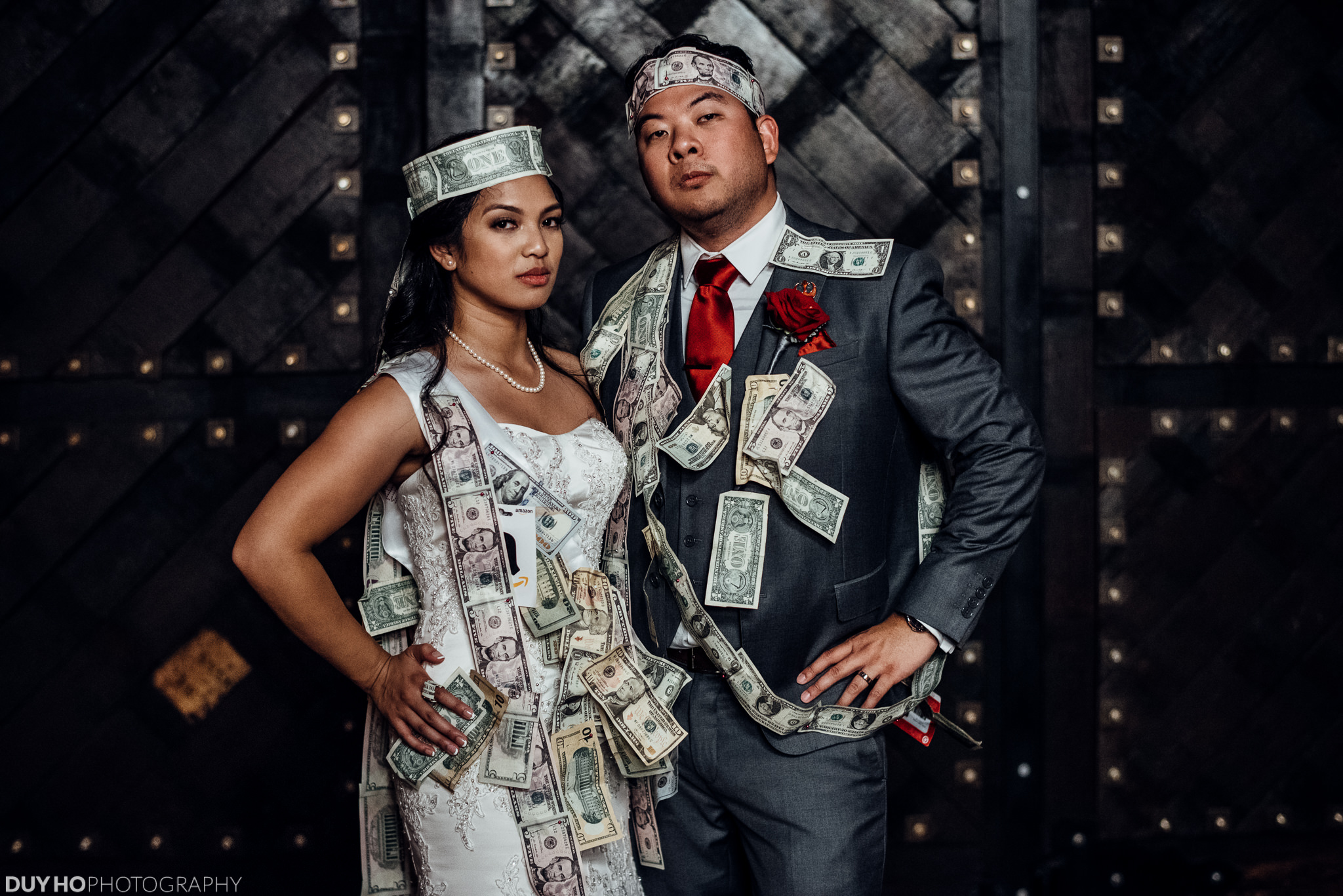 Playful wedding portrait with money garlands